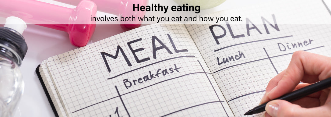 Open meal planning notebook showing meal plan grid for Breakfast Lunch Dinner, with a pink dumbbell and water bottle in the background.
